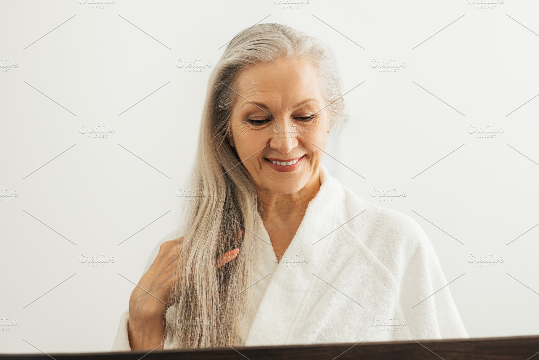 Senior woman in bathrobe, a Person Photo by Artem Varnitsin