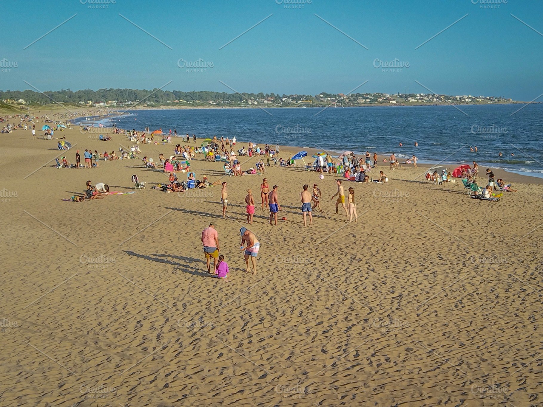Wide shot of a crowded beach on a sunny day, a Person Photo by DanFLCreativo