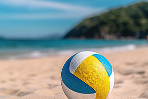 Volleyball on sandy beach with clear blue sky and gentle waves in the backgroun, a Sports & Recreation Photo by AlyaAnd