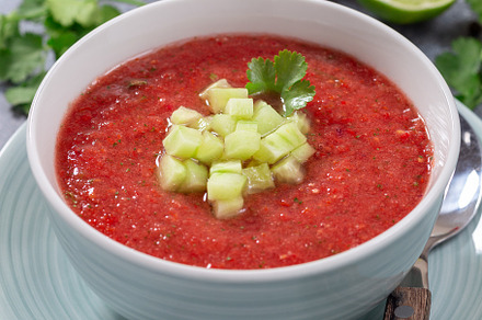 Gazpacho soup garnished with cucumber and cilantro, in bowl, horizontal closeup, a Food & Drink Photo by iuliia_n