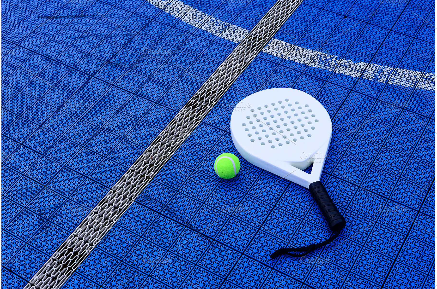 A padel racket and ball. on blue, a Sports & Recreation Photo by Yulia Furman