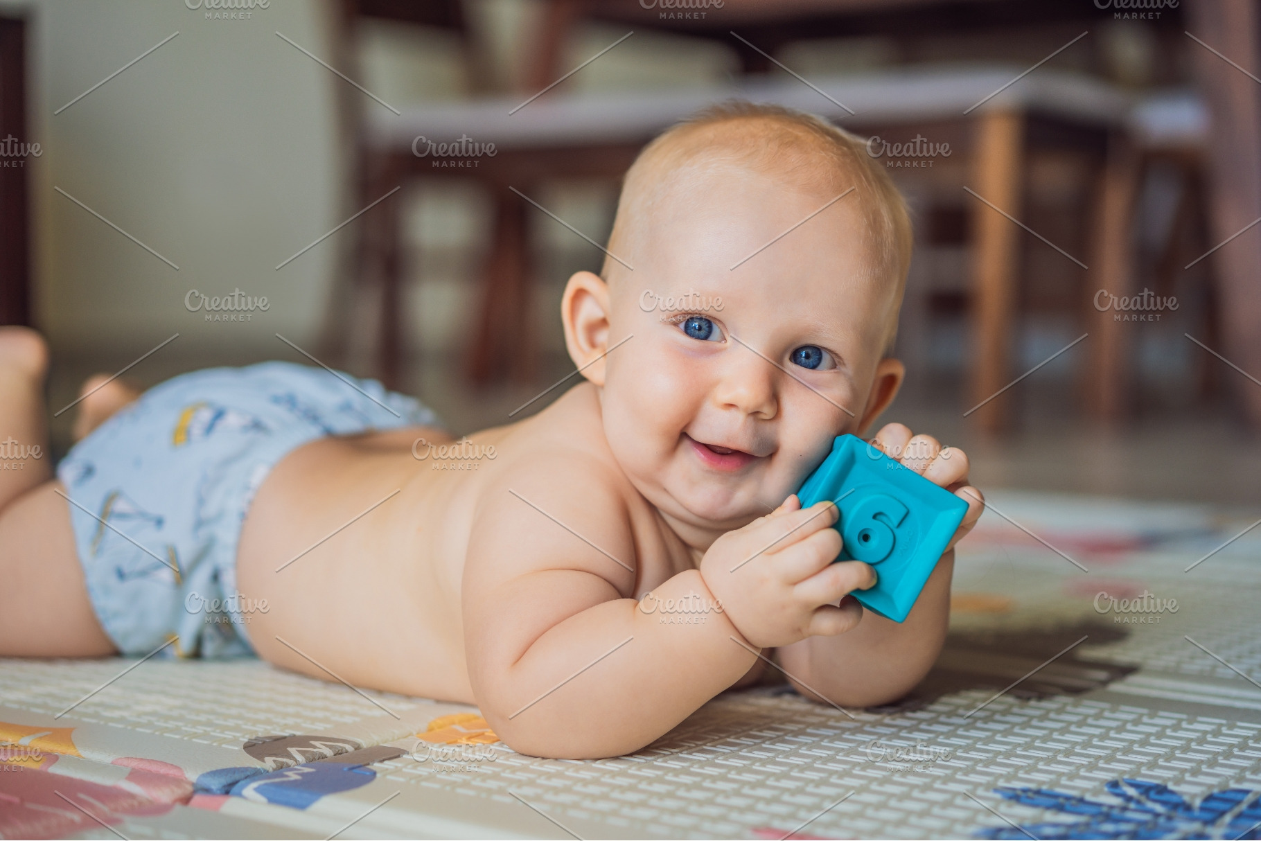 Smiling baby playing with a textured, a Person Photo by Elizaveta Galitskaya