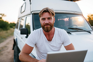 Man with laptop is engaged in remote, a Person Photo by Lermont51