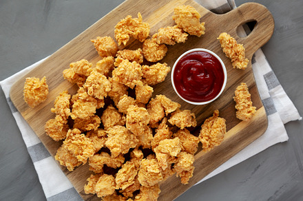 Homemade Crunchy Popcorn Chicken with Ketchup on a Board, top vi, a Food & Drink Photo by LiudmylaChuhunova