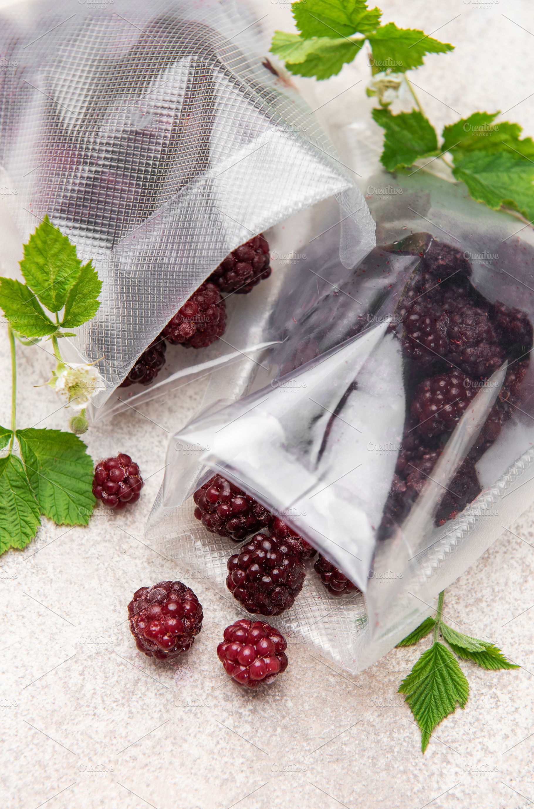 Frozen blackberries spilling from vacuum seal bags, a Food & Drink Photo by Olena Rudo