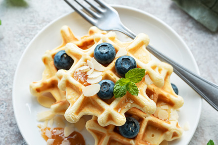 Freshly baked waffles with fresh  blueberries, a Food & Drink Photo by Olena Rudo