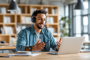 Man on video call in modern office w, a Photo by Pixeness Studio