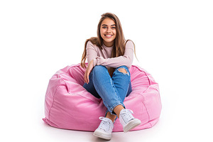 Attractive woman sitting on beanbag chair on white background, a Person Photo by AlyaAnd