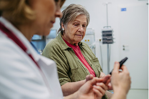Female doctor using blood glucose, a Technology Photo by HalfPoint