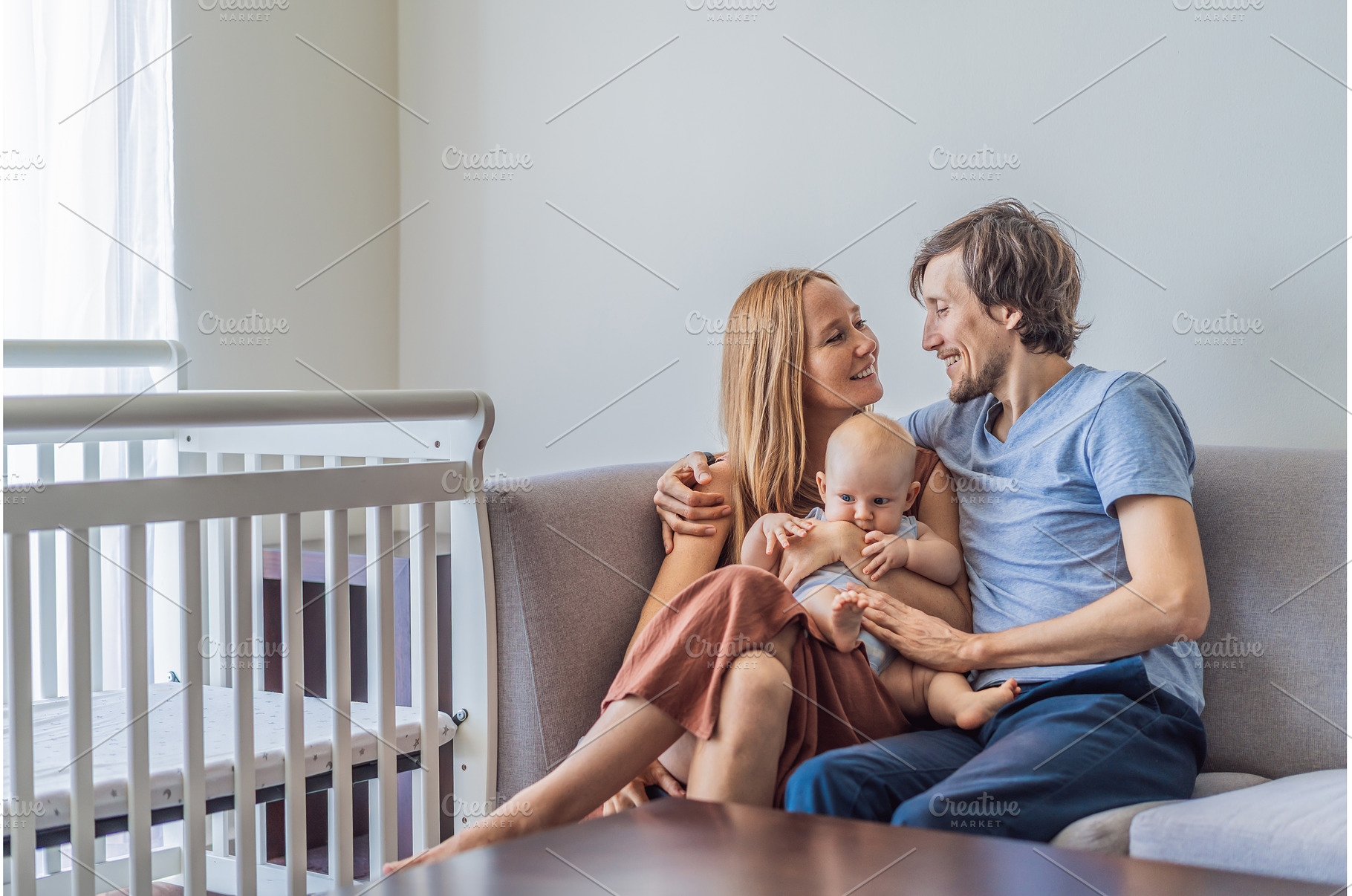Mother and father sitting on sofa, a Person Photo by Elizaveta Galitskaya