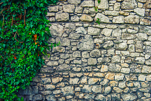 Old stone wall containing wall, stone, and old