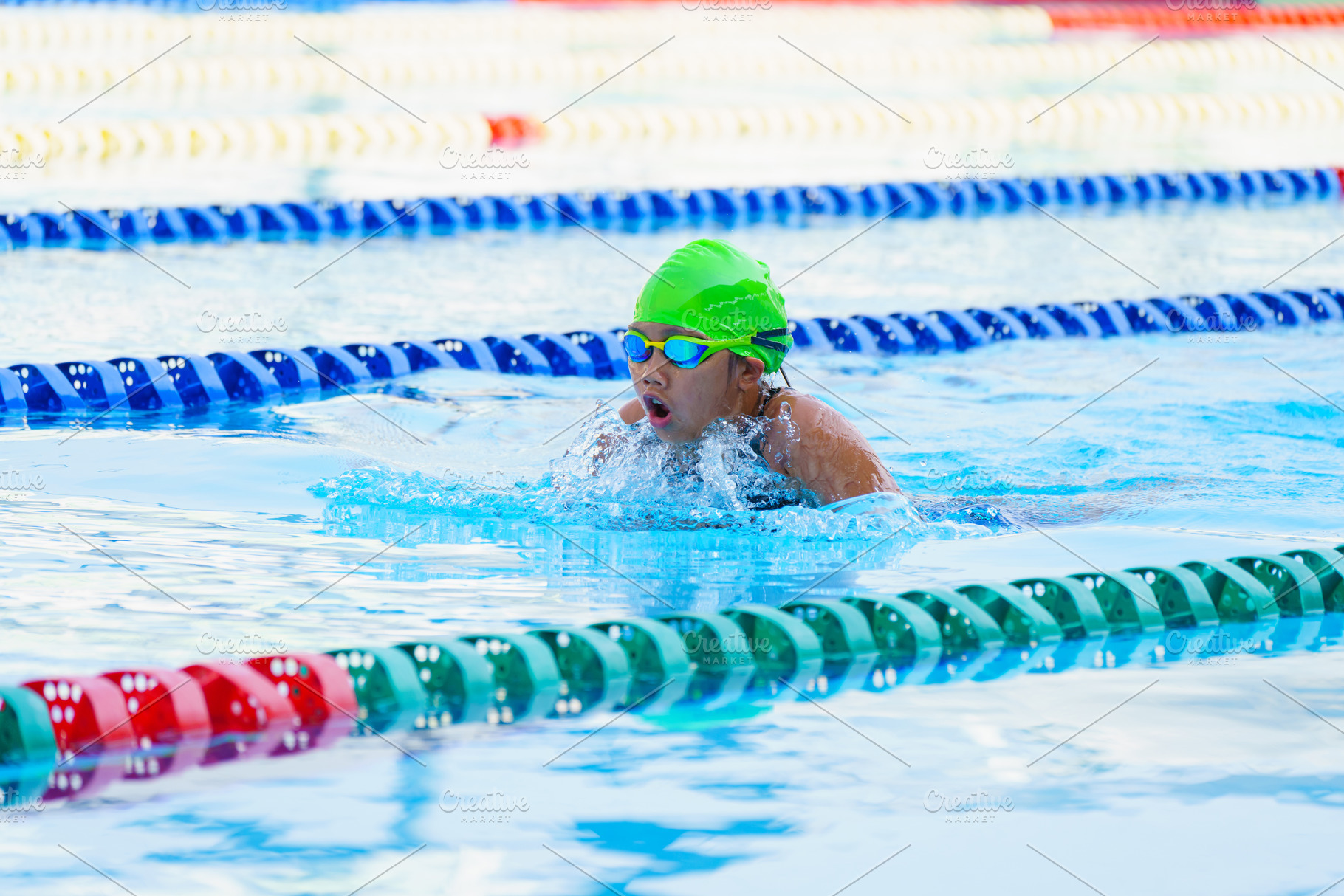 Swimmer child swims breaststroke swimming style in a race swimmi, a Sports & Recreation Photo by Casanowe-studio