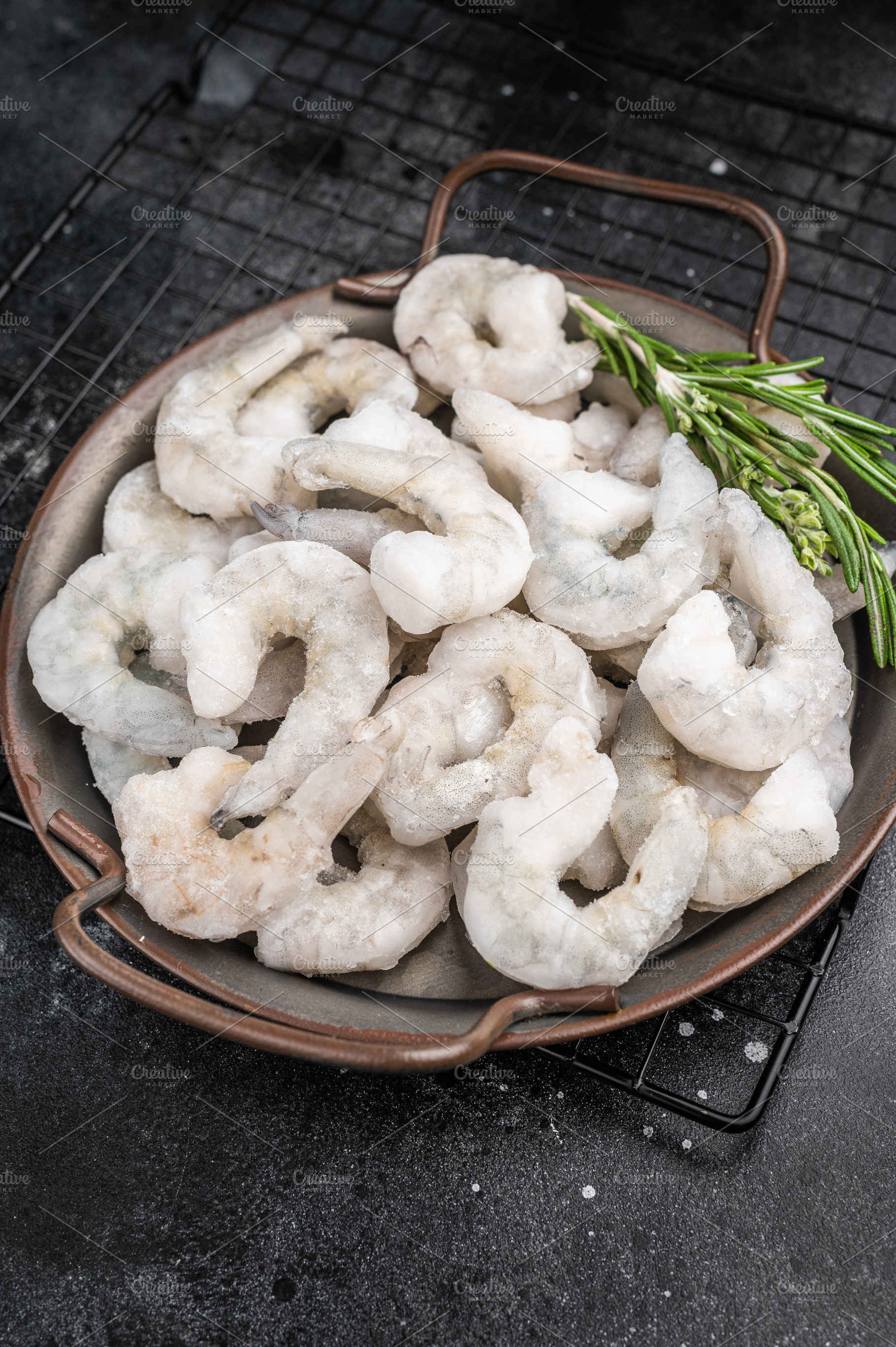 Frozen raw shrimp prawns in a rustic metal bowl with fresh rosem, a Food & Drink Photo by composter-box@mail.ru