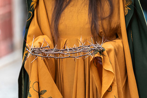 Woman holding crown of thorns representing Jesus Christ passion, a Holiday Photo by Antonio Gravante Market