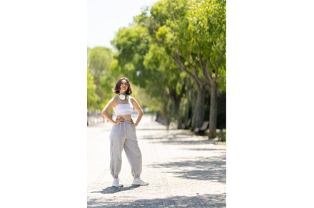 A woman is standing on a sidewalk in