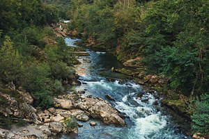 Crystal-clear river between green mo, a Nature Photo by Perpis
