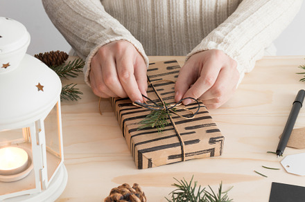 Woman wrapping a christmas gift,JPEG
