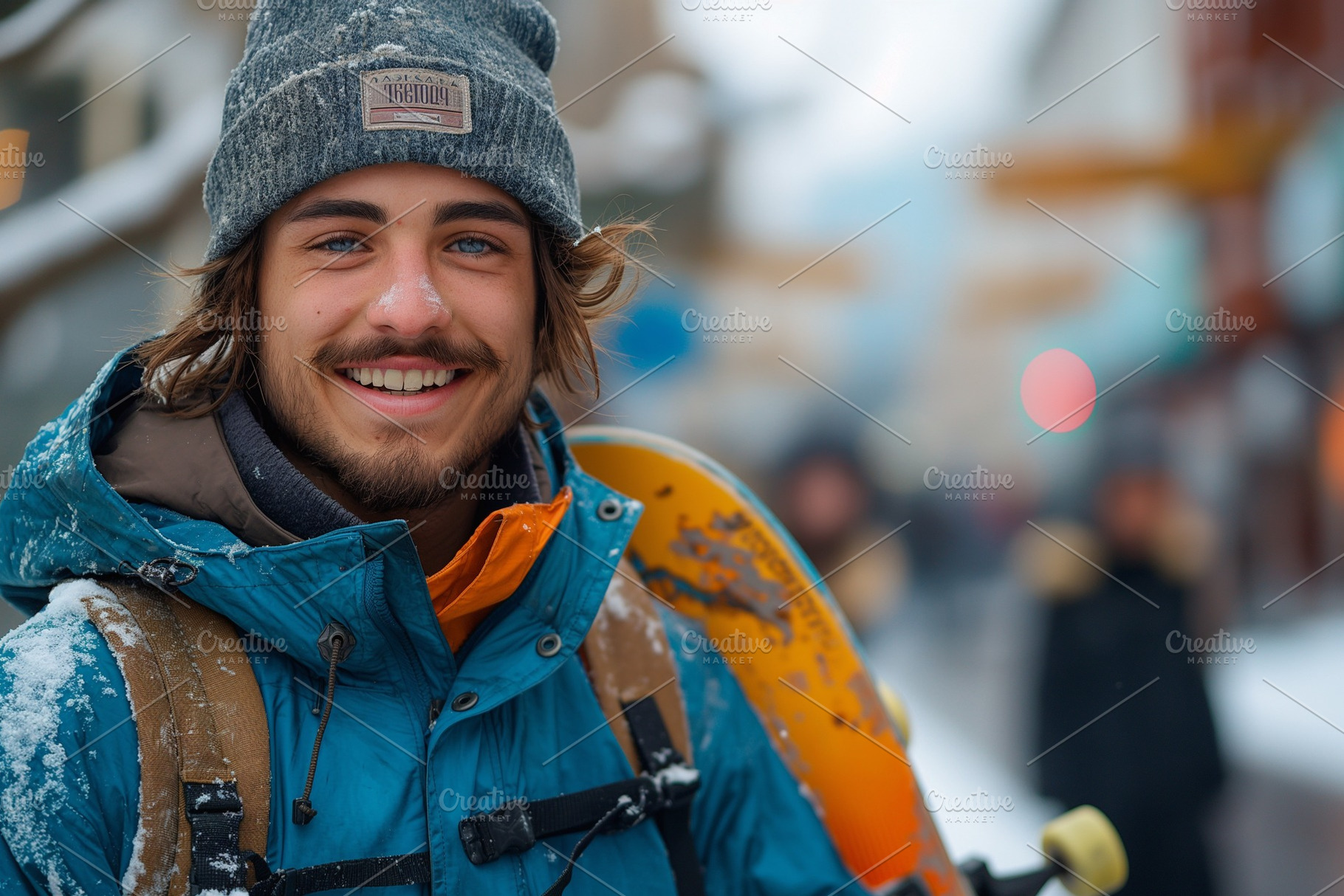 A smiling young Caucasian man in winter gear poses with a skateboard in a snowy, a Person Photo by ImageMir