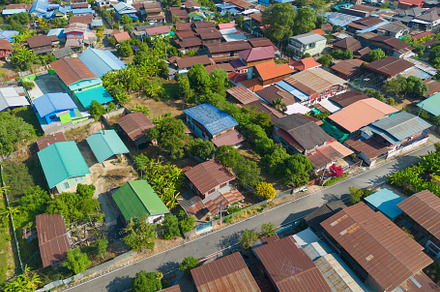Aerial view of local residential neighborhood roofs. Urban housi