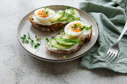 Bread toast, boiled eggs, avocado slice, microgreens on a plate, a Food & Drink Photo by Olena Rudo