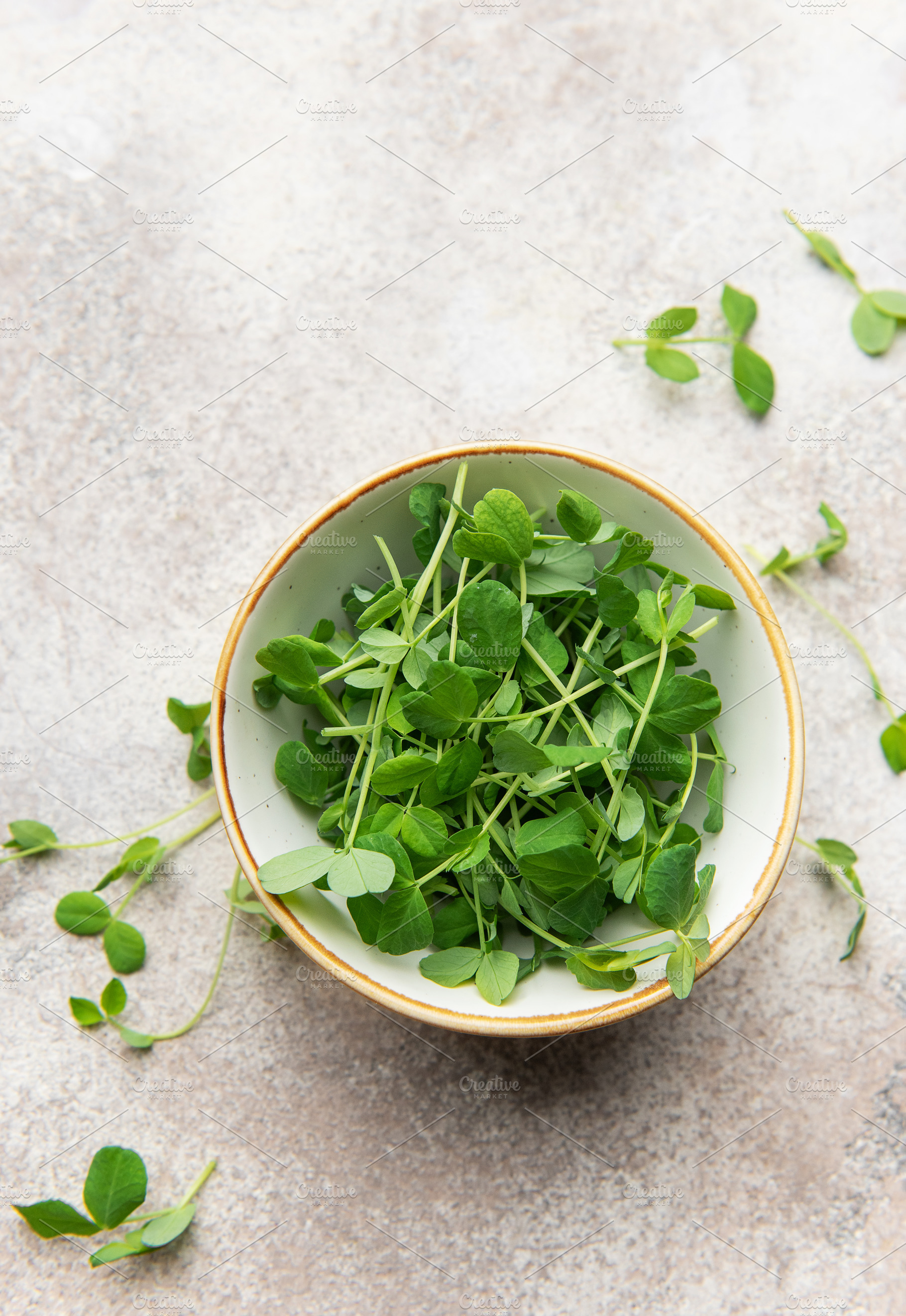 Green pea shoots in bowl, healthy microgreens for fresh eating, a Food & Drink Photo by Olena Rudo