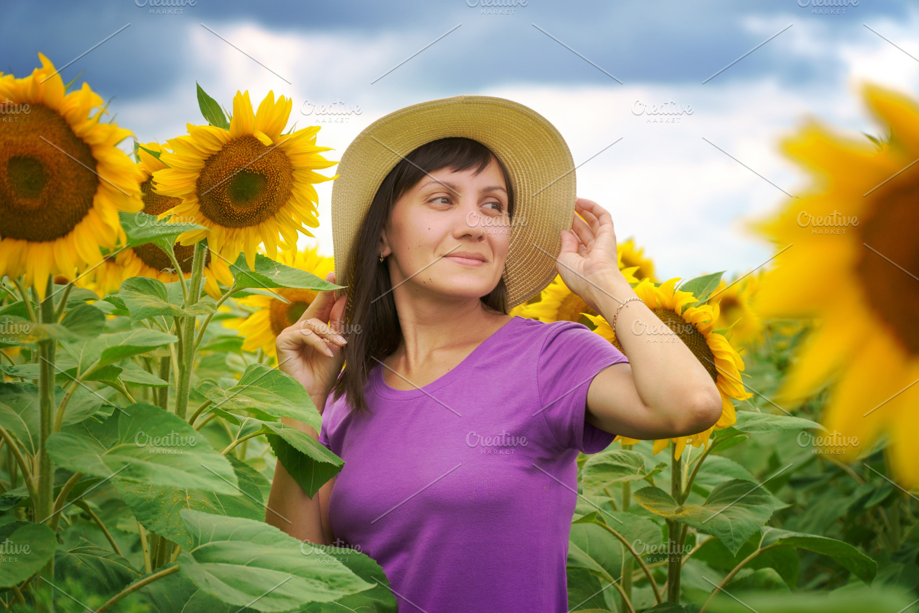 Woman in sunflower field at day., a Photo by djgis