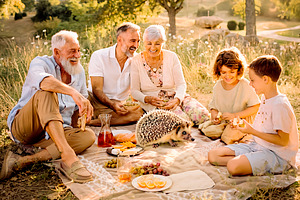 Family enjoying a warm afternoon picnic with small african pygmy, a Person Photo by DanFLCreativo