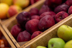 Vitrine with different types of apples exhibited at supermarket, a Photo by Prostock-Studio