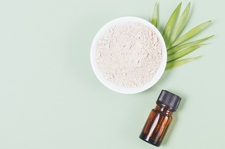 Natural cosmetic clay next to bottle of essential oil, a Beauty & Fashion Photo by progressman