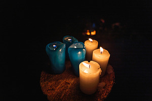 Lit Candles on Wooden Surface in Dark Atmosphere, an Abstract Photo by Red Hot Chili Pepper Shop