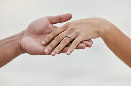 Engagement ring, hands and proposal of engaged couple romantic marriage celebration. Zoom on diamond jewelry finger for love, save the date and announcement of special occasion in commitment together, a Photo by Peopleimages.com