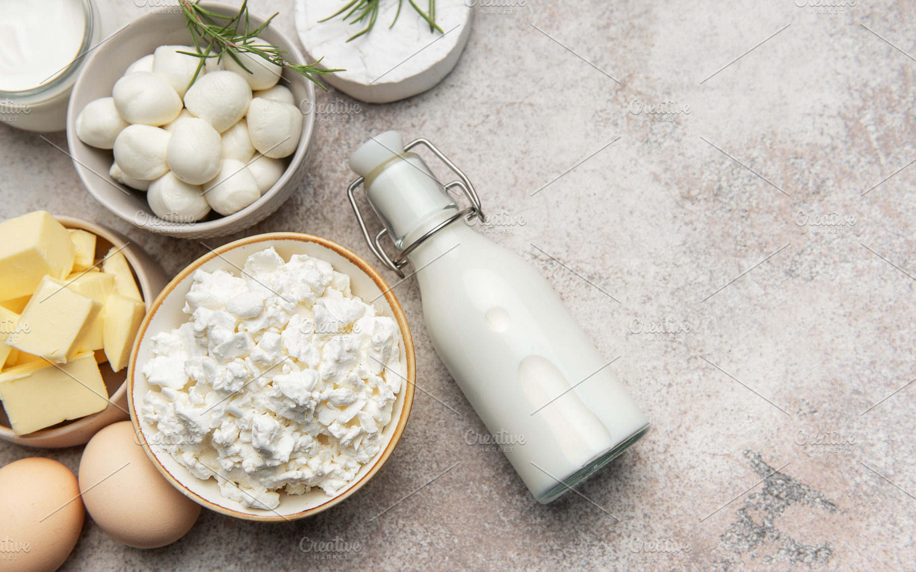Assortment of fresh dairy products on textured background, a Food & Drink Photo by Olena Rudo