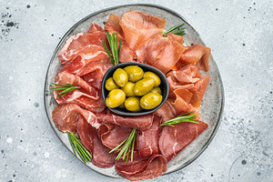 Bresaola, prosciutto and coppa slices with green olives on a rus, a Food & Drink Photo by composter-box@mail.ru