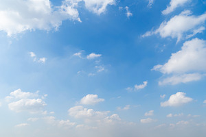 Clear blue sky with white fluffy clouds at noon. Day time. Abstr