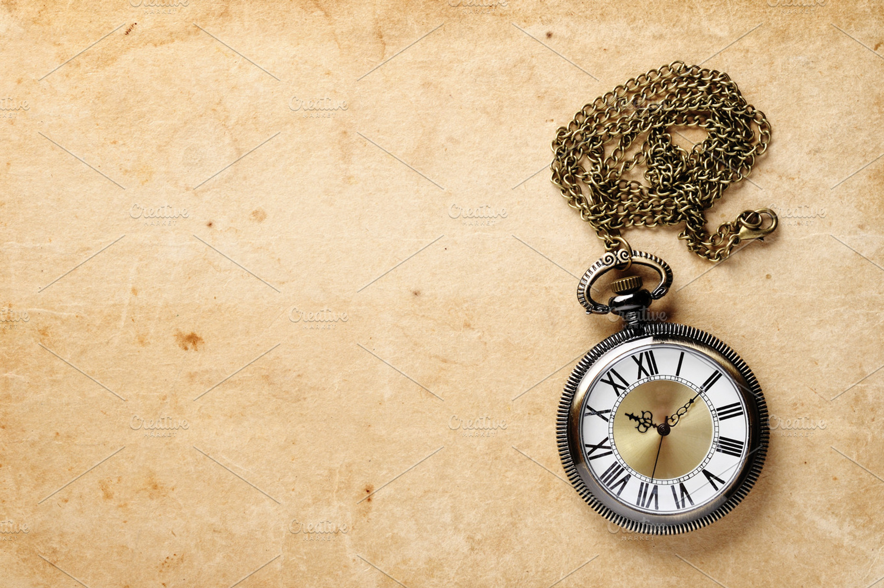 Vintage pocket watch featuring accessory, chain, and bronze