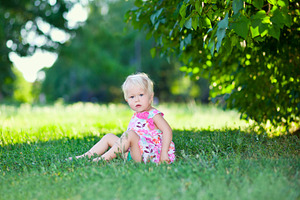 Baby sitting on green grass, a Photo by saiko3p