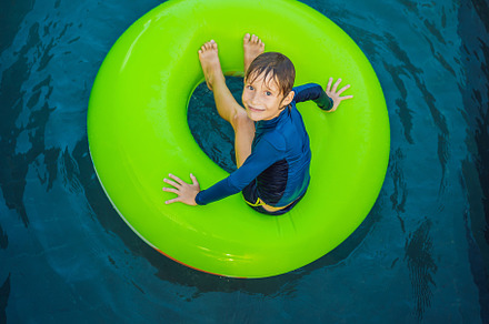 Little boy swimming with rubber ring stock photo containing boy and leisure, a Sports & Recreation Photo by Elizaveta Galitskaya