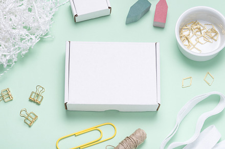 White Cardboard box on color office desk, a Background Photo by MDBildes