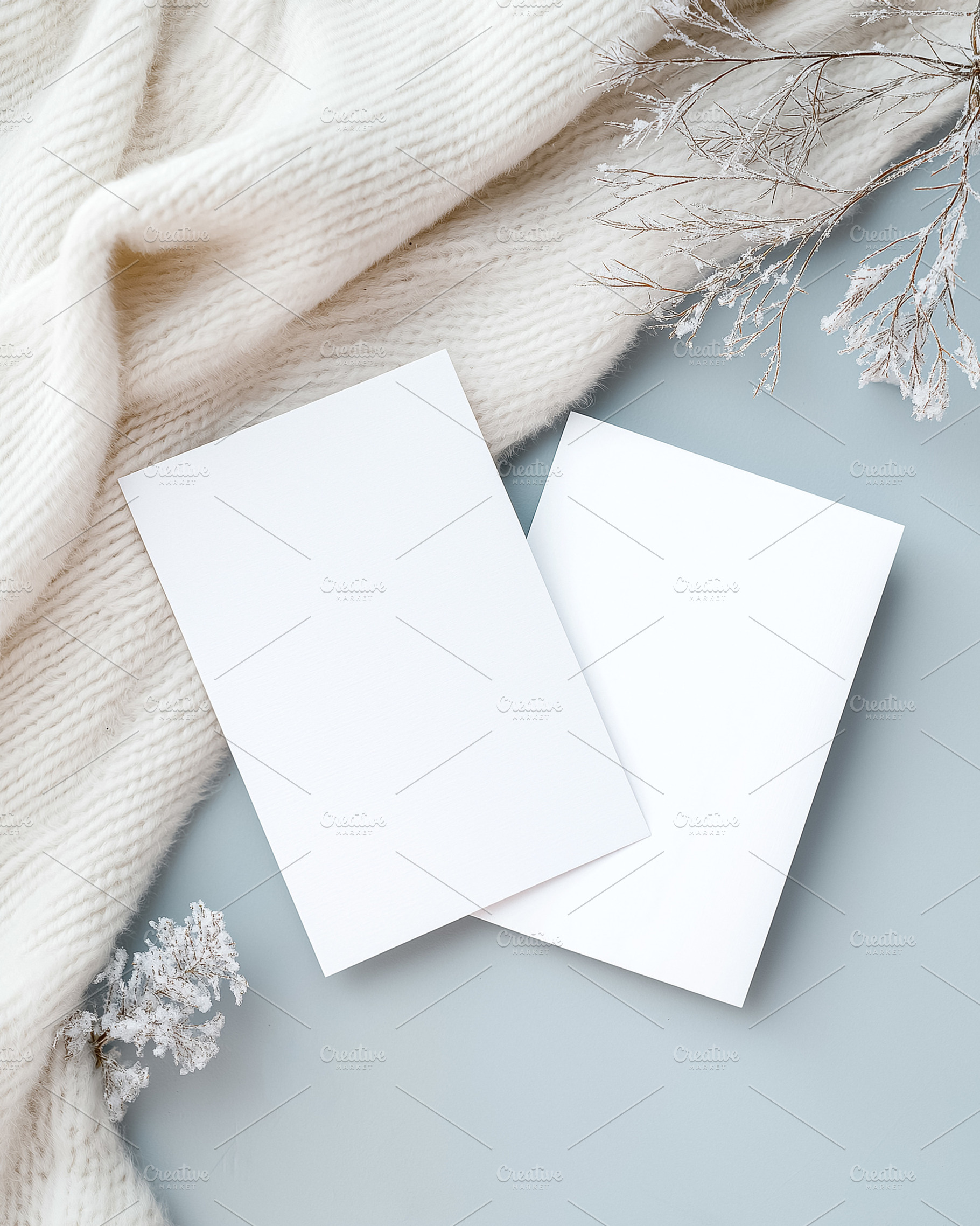 Two blank cards mockup on cozy white knit sweater with frosted branches, flat l, a Holiday Photo by Studio ANNA