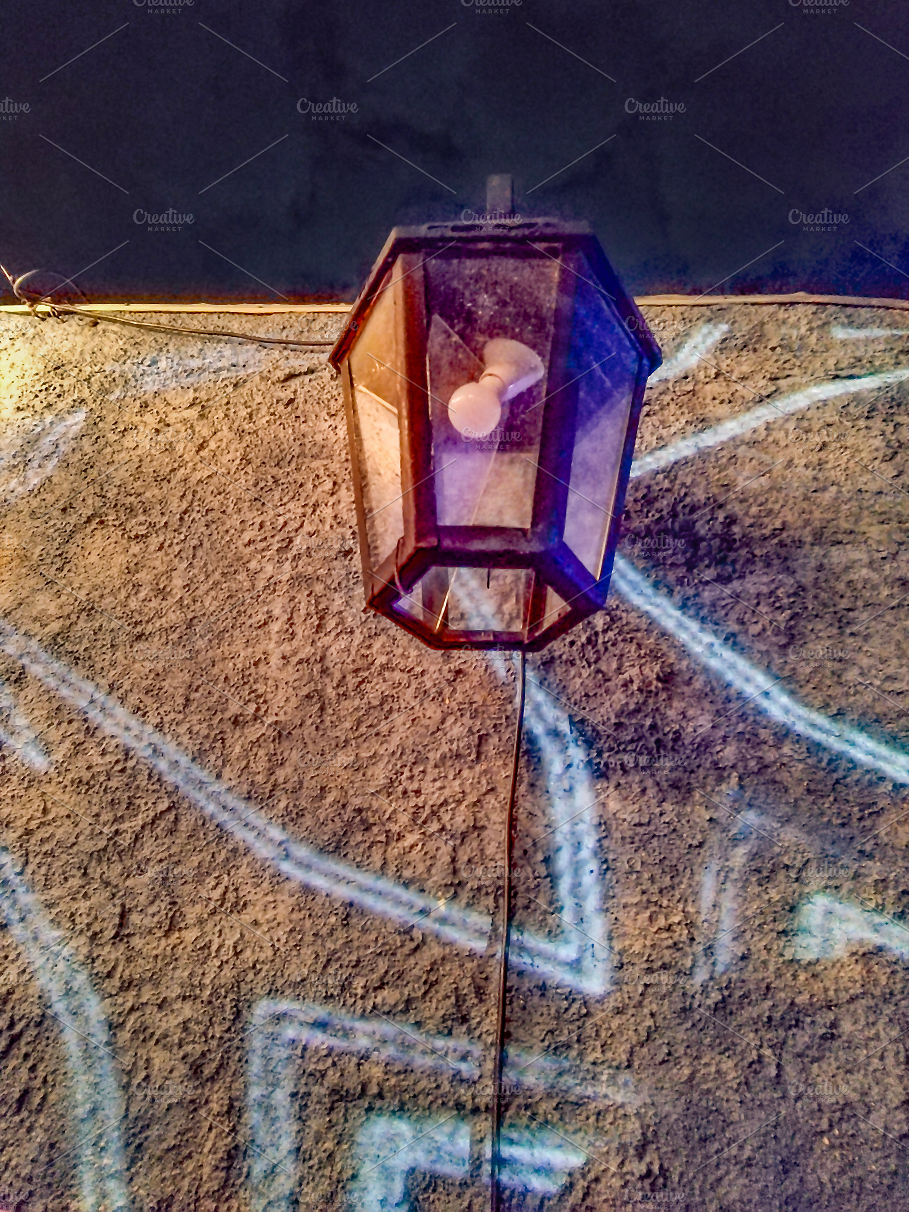 A lantern hanging on a wall, illuminated by soft light, an Architecture Photo by DanFLCreativo