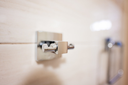 Close up of a towel holder in a modern bathroom. Selective focus, a Photo by AS photostudio