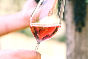 Man with glass of wine in vineyard, a Background Photo by hitdelight