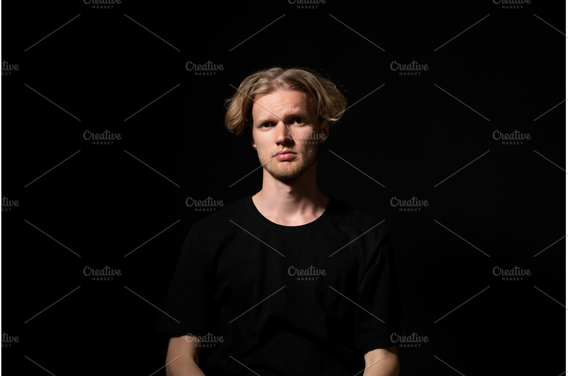 Young blond man staring directly, a Person Photo by volodymyrshtun13795
