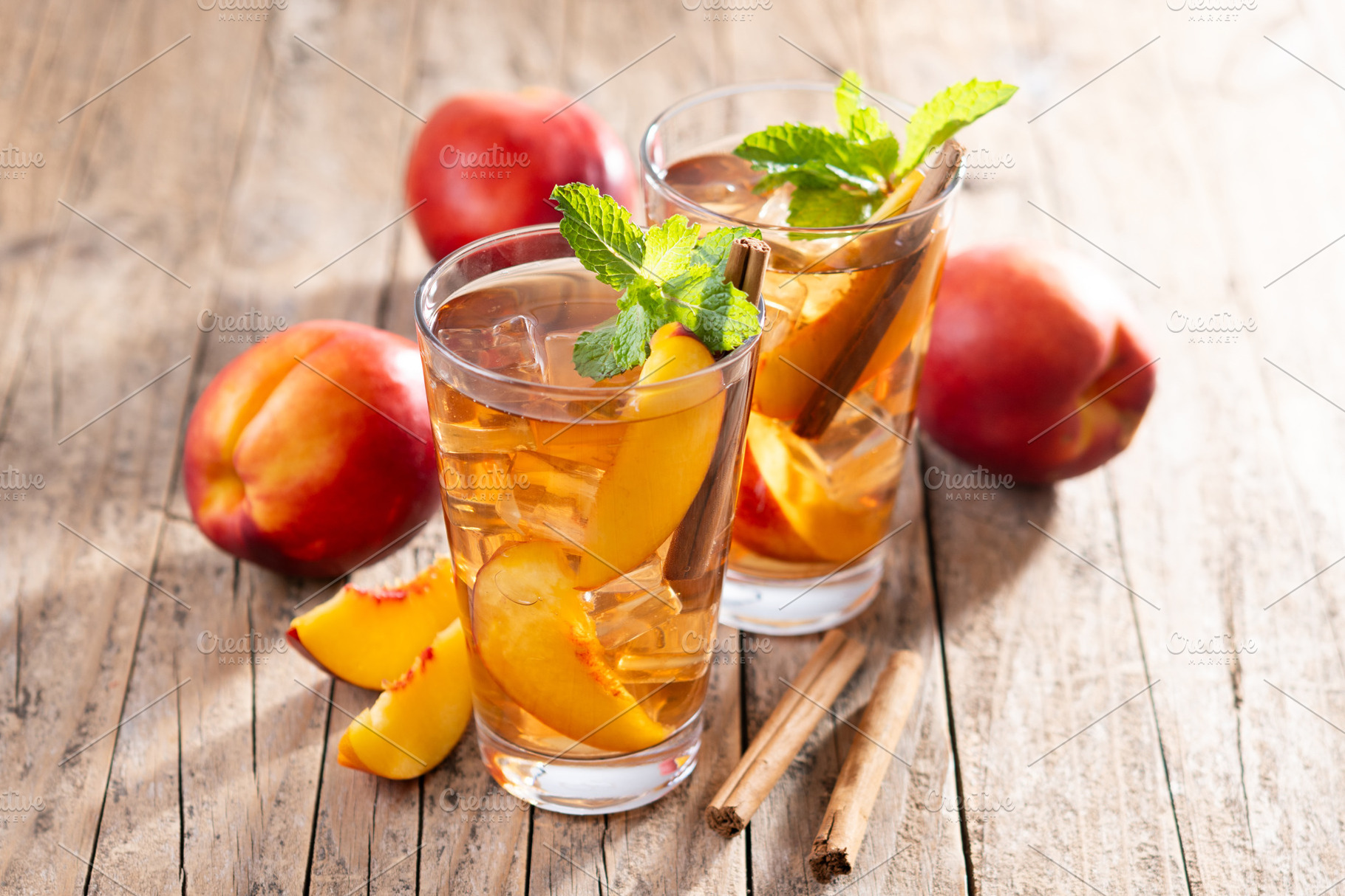 Refreshing peach iced tea in glass with ice cubes and cinnamon, a Food & Drink Photo by etorres69