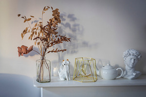Dried branches in a glass jar on a w, a Wallpaper Photo by Imaginarium