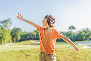 Boy wearing a pilot hat running, a Nature Photo by Elizaveta Galitskaya