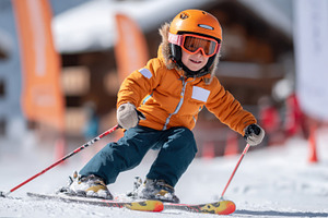 Young child skiing on snowy slope, a Sports & Recreation Photo by AlyaAnd