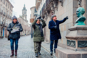 Mature men travelers exploring a historic urban district in wint, a Person Photo by DanFLCreativo