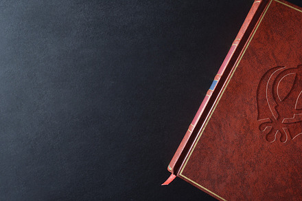Background with sacred book with engraved sikh symbol top view, a School & Education Photo by Davizro's Market