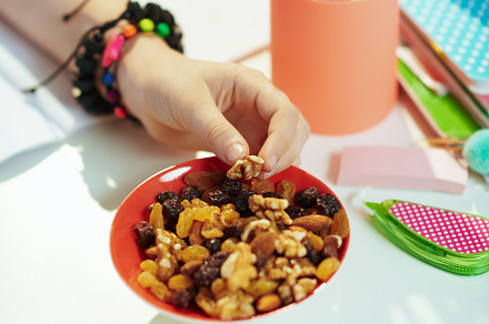 Modern child at home in sunny day eating healthy snack, a School & Education Photo by Alliance Images